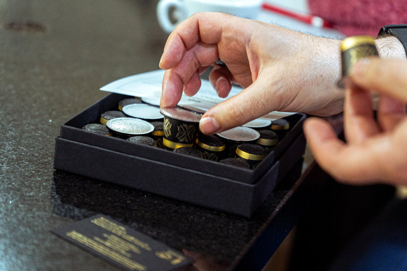 A Difference Coffee capsule being taken from its box